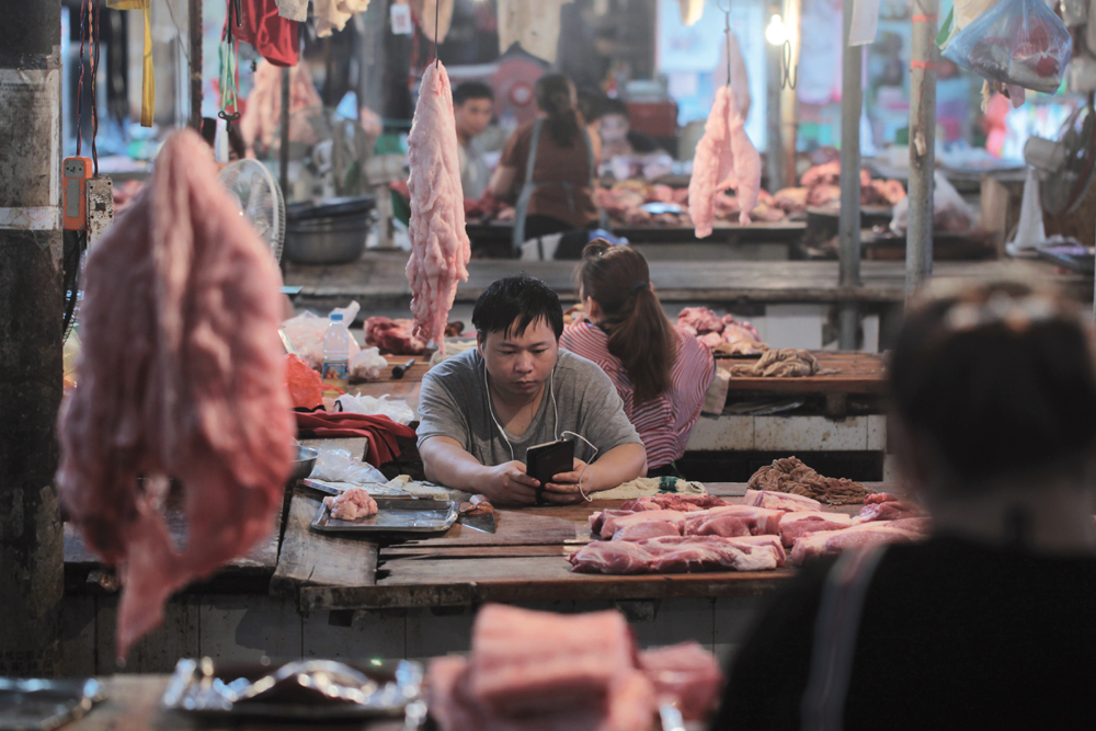 Pork accounts for nearly two-thirds of China’s meat consumption and with African swine fever decimating Chinese production, Canada’s pork sector had hoped to see its exports to China jump rather than be banned. Pictured here are pork vendors at a market in Yunnan province in May.