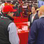 Agriculture and Forestry Minister Devin Dreeshen, seen here talking to farmers at Agri-Trade, says cuts to his department will be found through efficiencies and not by cutting programs that impact producers.