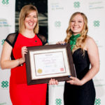 Courtney Taylor (right) is presented with her Leadership Excellence Award of Distinction by Stefanie Nagelschmitz, chair of Canadian 4-H Foundation.