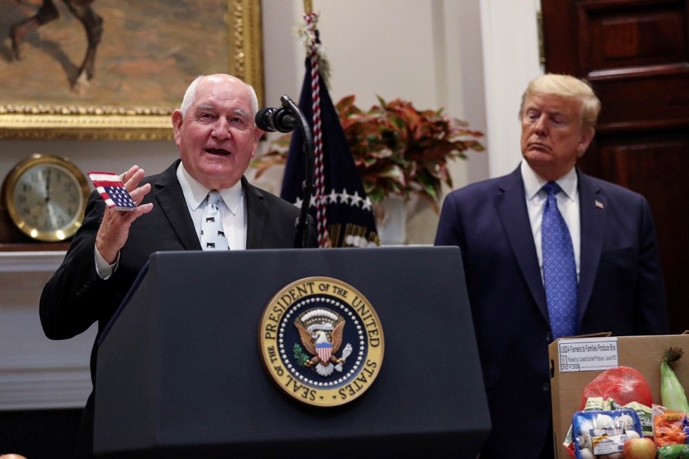 U.S. Agriculture Secretary Sonny Perdue holds a U.S. flag-themed face mask while speaking about the U.S. food supply chain as President Donald Trump listens during a COVID-19 pandemic response event at the White House on May 19, 2020. (Photo: Reuters/Leah Millis)
