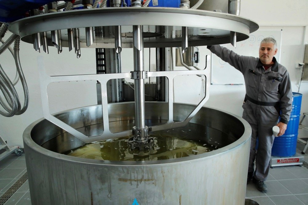 Gerald Grand, a staff member at Agolin, a Swiss maker of feed additives based on botanical compounds, works on a mixture of components at Biere, Switzerland on Sept. 26, 2018. (Photo: Reuters/Denis Balibouse)
