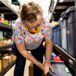 Volunteer Ann Kendall checks on supplies at the County of Lamont Food Bank.