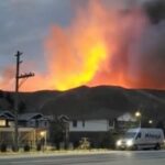 Smoke rises from a wildfire over a hill at Kamloops, B.C. on July 1, 2021, in this screen grab obtained from a social media video. (Nicole Ritter via Reuters)