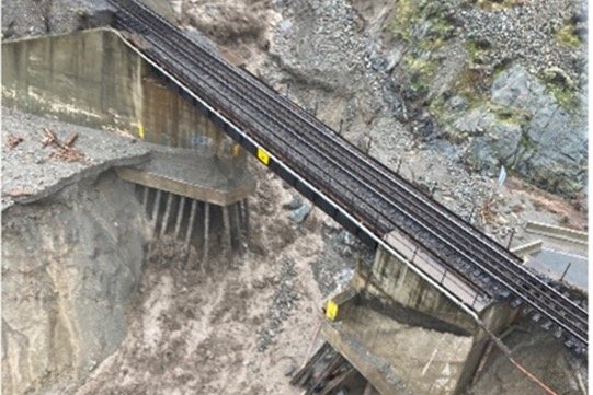 An aerial view shows a damaged road as a flood sweeps through, near Lytton, B.C. on Nov. 15, 2021. (Handout photo from B.C. Ministry of Transportation and Infrastructure via Reuters)

