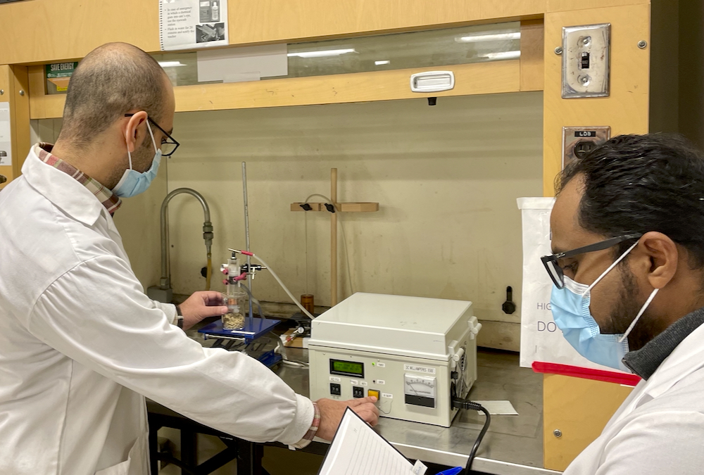 Researcher M.S. Roopesh (right), works with PhD student Ehsan Feizollahi on their lab-scale cold plasma unit to treat barley grain. The team hopes to commercialize the technology for broader use in agriculture and the food industry.