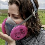 It’s not just the type of mask — fit is critical. This photo from a booklet called Save Your Breath: Respiratory Health in Agriculture shows how to do a positive pressure check to ensure a proper seal has been obtained with this half-face respirator.