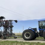 Here’s an example of both a tractor and trailing equipment safely travelling under an overhead power line. However, it doesn’t always work that way. Producers should know the size of their equipment and the laws around safe transportation height before attempting to travel under a line.