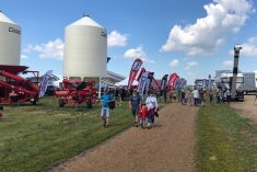 Visitors walk the grounds at Ag in Motion on July 19, 2022 after taking cover from a rain shower. (Liam O&#8217;Connor photo)
