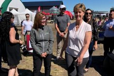Federal Ag Minister Marie-Claude Bibeau (r) visits the Ag in Motion outdoor farm show near Langham, Sask. on July 20, 2022. (Greg Berg photo)