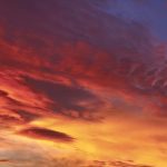 To get a red sunrise or sunset, you need a large number of particles in the air for the sunlight to bounce off, causing us to see more red light.