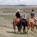 Jerry Baerg and two of his children survey a section of their native grassland near Linden.