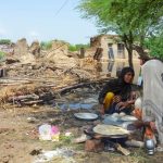 People cook food beside their damaged house following rains and floods during Pakistan’s monsoon season at Jafarabad, about 400 km north of Hyderabad, on Aug. 28, 2022. (Photo: Reuters/Amer Hussain)