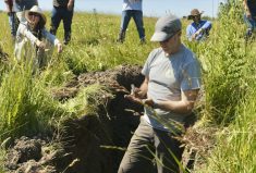 University of Alberta researcher Derek MacKenzie (foreground) wants his soil management app to also be a vehicle for carbon credit training and crowdsourcing management practices among producers.