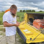 Crop scout Luke Mullet measures ears of corn on the Pro Farmer Midwest Crop Tour in Iowa in late August. Tour participants were surprised by the lower-than-expected corn yields and that’s important because corn is considered “the king of grains” and a leading indicator of future prices, said market analyst Errol Anderson.