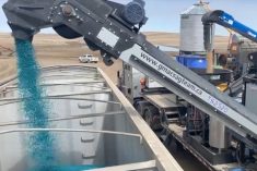 A G-Mac&#8217;s custom seed treatment unit loads a truck with treated peas in a 2020 video screengrab. (G-Mac&#8217;s AgTeam via YouTube)
