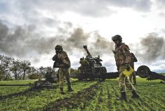 Artillerymen of Ukraine’s armed forces set up a field gun in a winter wheat field Oct. 27, 2022, in southeastern Ukraine.