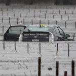 A submerged and abandoned car is seen in floodwaters near a vineyard after winter storms at Forestville, California on Jan. 13, 2023. (Photo: Reuters/Fred Greaves)
