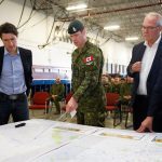 Prime Minister Justin Trudeau, federal Emergency Preparedness Minister Bill Blair and Edmonton MP and Tourism Minister Randy Boissonnault are briefed by Canadian Forces Lt. Col. Ben Schmidt at CFB Edmonton on May 15, 2023. (Photo: Reuters/Amber Bracken)