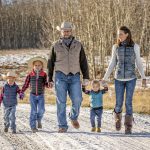 Matt and Angela Kumlin take their kids Bennett, Wade and Rachel for a stroll on their ranch near Cochrane. The Kumlins received $70,000 from the On Farm Climate Action Fund to build a pasture pipeline watering system for more efficient and sustainable grazing.
