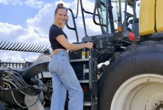 Lynn Dargis hops on her combine. Dargis has been running the farm and ranch since her parents both tragically died. She was 20 years old when it happened.