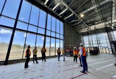 A construction crew confers this summer at the entrance to Lethbridge’s Agri-Food Hub and Trade Centre, which is set to host Ag Expo later this month.