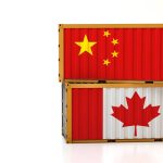 Two stacked shipping crates, the top one with a Chinese flag and the bottom with a Canadian flag.