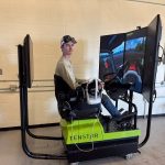 Karson Wasylciw, a student with Northwestern Polytechnic's agriculture operations program, drives a simulated tractor .