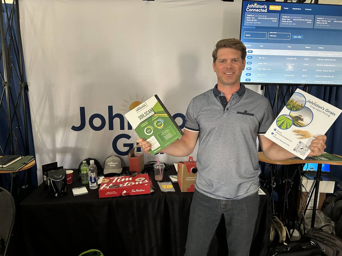 Joel Merkosky, president of Johnston’s Grain, shows off some of the firm’s brochures at its booth at the Ag in Motion 2025 show in Langham, Sask.Joel Merkosky, president of Johnston’s Grain, attended Ag in Motion 2025 to explain his company’s move into regenerative agriculture. Photo: Sean Pratt