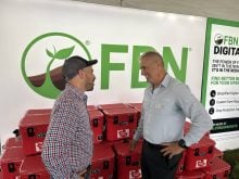 Nigel Buffone, left, Farmers Business Network’s senior director of crop protection, talks to Breen Neeser, FBN’s general manager, at the Ag in Motion show in Langham, Sask. Photo: Sean
