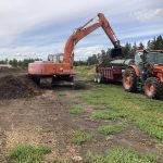 Ward Middleton -- an organic farmer located north of Edmonton -- mixes a row of compost with manure. He says any additional feedstock for composting or fertilizing is welcome.