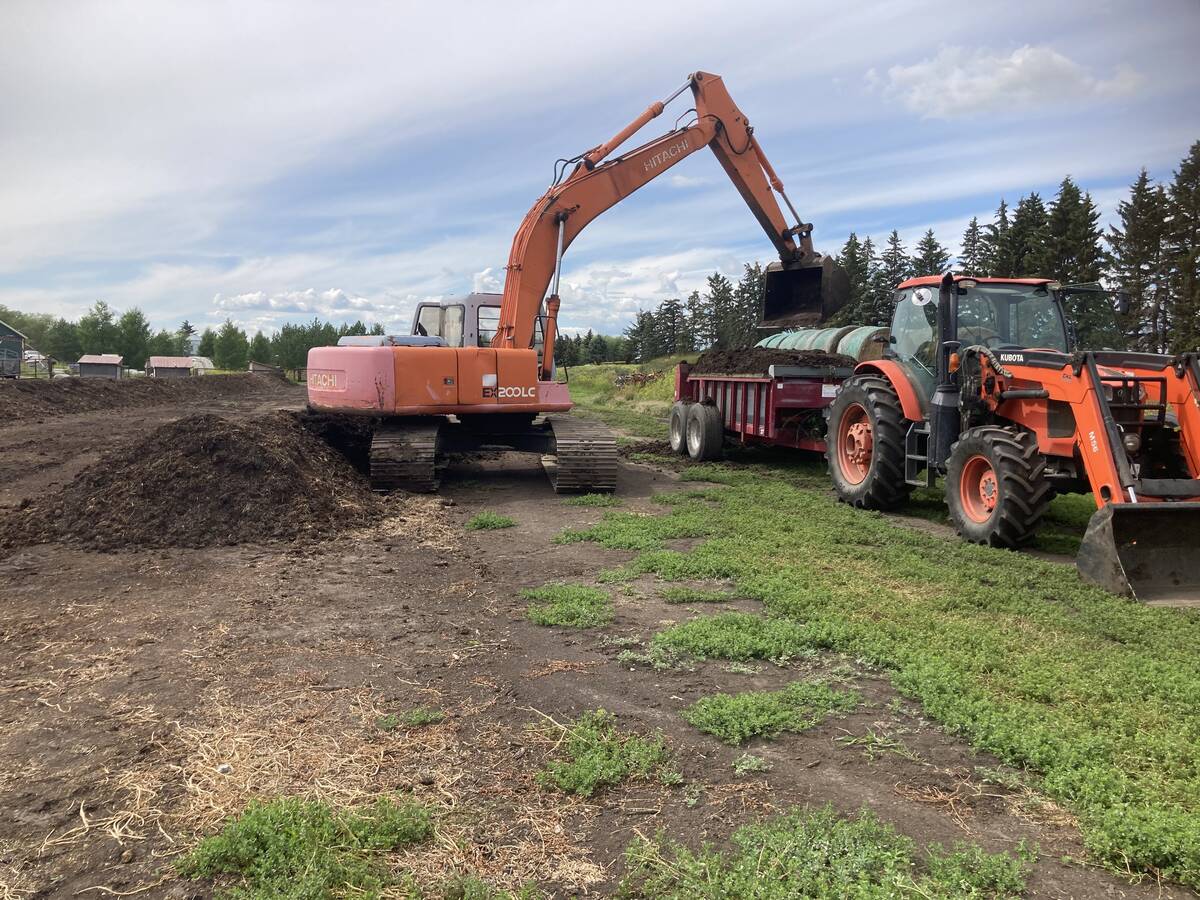 Ward Middleton -- an organic farmer located north of Edmonton -- mixes a row of compost with manure. He says any additional feedstock for composting or fertilizing is welcome.