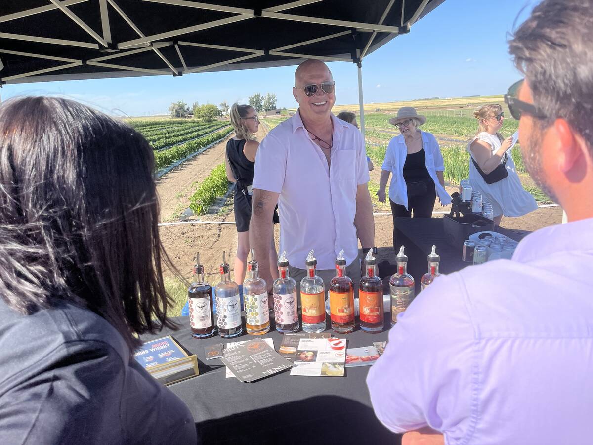 Lars Hirch of Pivot Spirits is all smiles at a Farm to Table tour at a farm in Barnwell, Alta., sponsored by Alberta Sugar Beet Growers. Hirch enjoys mingling with farming neighbours and adding value to the products they grow, and connecting onlookers back to the farm. Photos: Greg Price