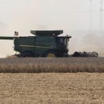 Heat waves are seen on an unusually warm September day as a farmer unloads his combine hopper into a waiting wagon as he harvests a soybean field in western Iowa in rural Woodbury County, Monday, September 29, 2025. Photo: Jerry Mennenga/ZUMA Press Wire
