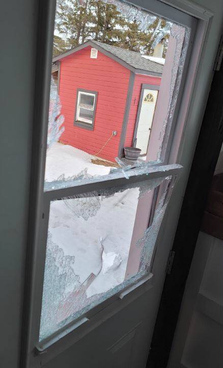 Selkirk RCMP released this photo of a smashed window at a rural residence in the RM of St. Clements in March 2023 after being called out to reports of a man with an axe smashing property. Two vehicles were also damaged. Photo: RCMP