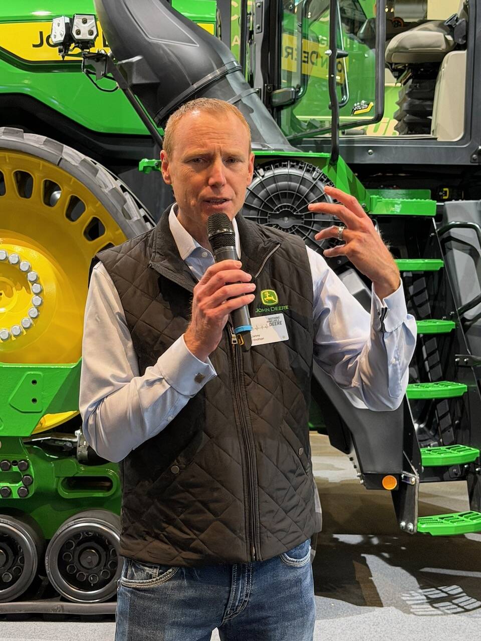 Jahmy Hindman of John Deere talked about the autonomous 9R tractor behind him at Agritechnica 2025. Photo: John Greig