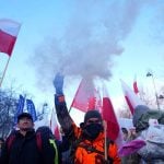 A demonstrator holds a flare as Polish farmers protest against the Mercosur trade deal in front of the Chancellery of the Prime Minister, in Warsaw, Poland, January 9, 2026. Photo: REUTERS/Aleksandra Szmigiel
