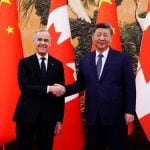 Canadian Prime Minister Mark Carney shakes hands with Chinese President Xi Jinping at the Great Hall of the People in Beijing on Friday, Jan. 16, 2026. 