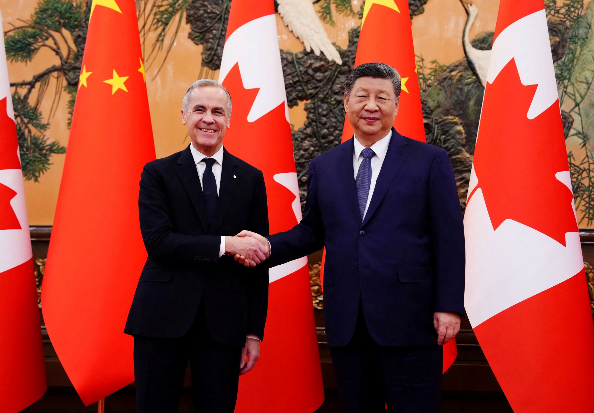 Canadian Prime Minister Mark Carney shakes hands with Chinese President Xi Jinping at the Great Hall of the People in Beijing on Friday, Jan. 16, 2026. 