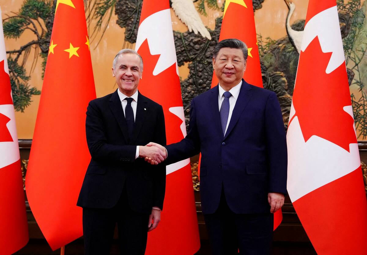 Canadian Prime Minister Mark Carney shakes hands with President of China Xi Jinping at the Great Hall of the People in Beijing, China on Friday, Jan. 16, 2026. Sean Kilpatrick/Pool via REUTERS
