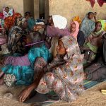 A displaced woman from Dalanj braids her grandmother's hair at a displacement registration center in El Obeid, North Kordofan State, Sudan, January 15, 2026. REUTERS/El Tayeb Siddig