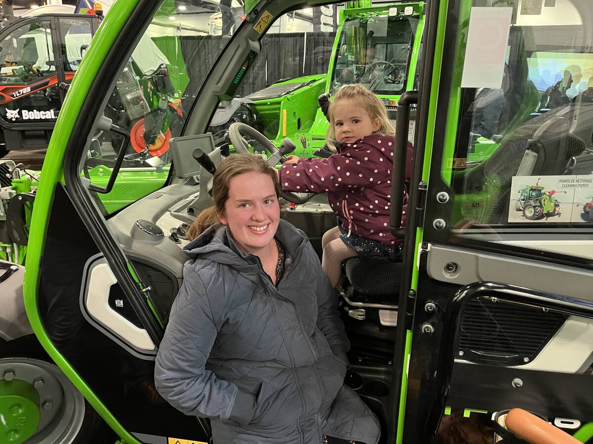 Nicole Muilwijk was able to get in some quality family time with daughter Beverly as the two explored a Merlo Manulift TF 27.6 telehandler at Lethbridge Ag Expo 2026. The Merlo factory in Italy, offers its products to 70-plus countries. Photo: Greg Price