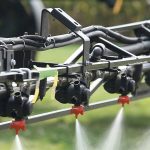 A close up of spray nozzles applying farm chemical to a field. Photo: File