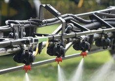 A close up of spray nozzles applying farm chemical to a field. Photo: File