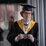 Paul Skretting smiles and holds up his valedictorian medal while wearing a graduation cap and gown at Lethbridge Polytechnic. The agronomy student credits his grandfather's farm for inspiring his career in agriculture. Photo: Courtesy Lethbridge Polytechnic