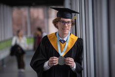 Paul Skretting smiles and holds up his valedictorian medal while wearing a graduation cap and gown at Lethbridge Polytechnic. The agronomy student credits his grandfather's farm for inspiring his career in agriculture. Photo: Courtesy Lethbridge Polytechnic
