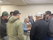 Reeve Tamara Miyanaga stands surrounded by agricultural producers and ratepayers at a public consultation session. The M.D. of Taber has finalized new grazing lease policies after years of heated debate. Photo: Greg Price
