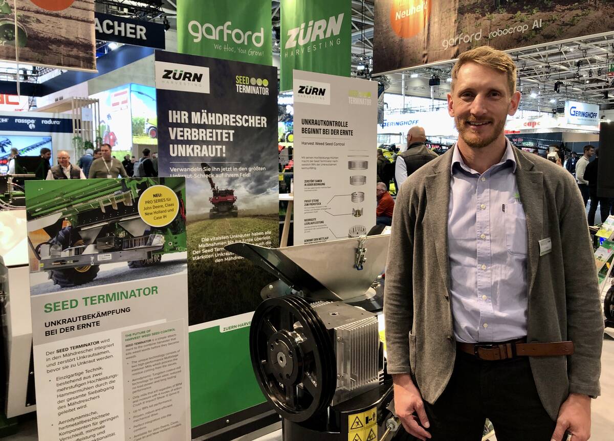 Nick Berry, founder and CEO of Seed Terminator, stands beside the company's weed seed destruction unit at Agritechnica 2025. Photo: Greg Berg