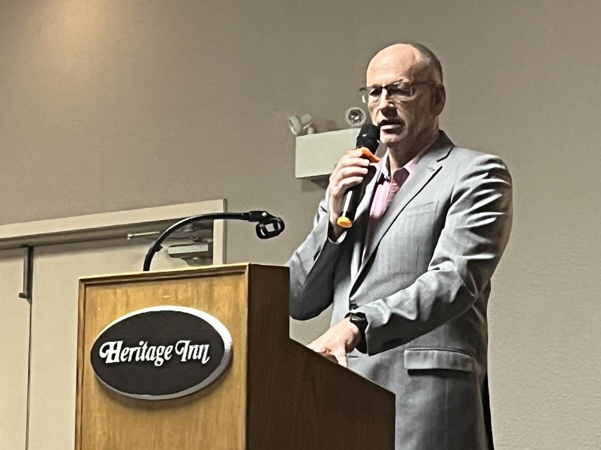 Terence Hochstein, executive director of Potato Growers of Alberta, speaks from a podium at the Heritage Inn during the south regional meeting in Taber, Alta. Photo: Greg Price