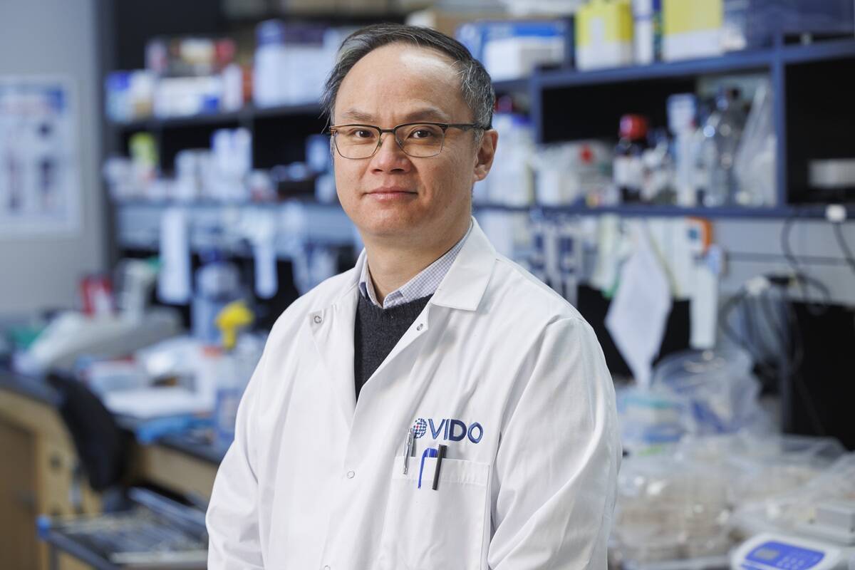 Jeffrey Chen, principal investigator at the Vaccine and Infectious Disease Organization (VIDO), in a lab coat at the University of Saskatchewan. Photo: David Stobbe