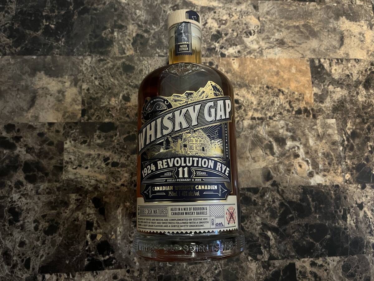 A bottle of Whisky Gap 1924 Revolution Rye, an 11-year-old Alberta-made Canadian whisky, displayed on a dark marble surface. Photo: Greg Price